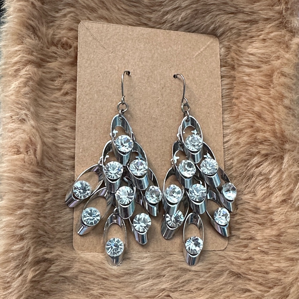 Silver-plated chandelier earrings with white rhinestones.